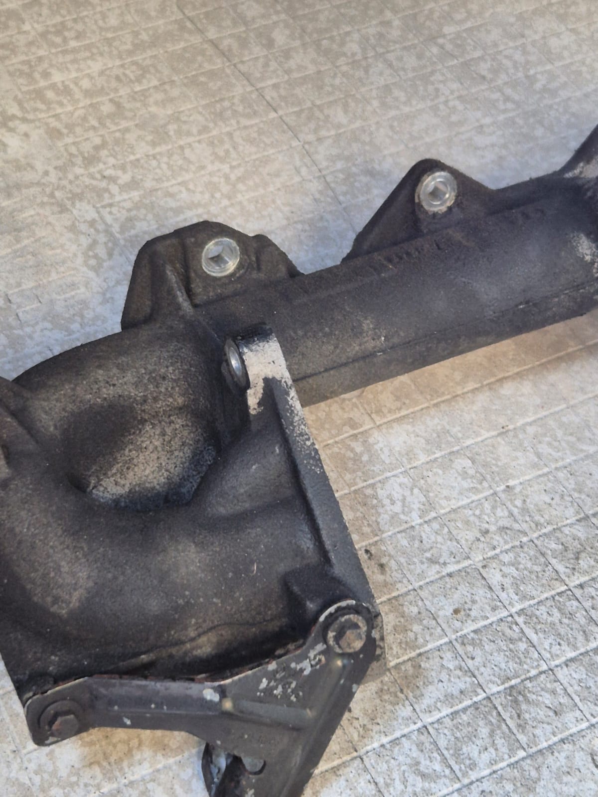 Engine manifold before laser cleaning — carbon and grease build-up