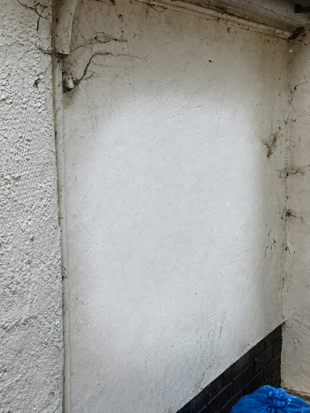 Clean concrete wall after laser graffiti removal — Chelmsford retail park
