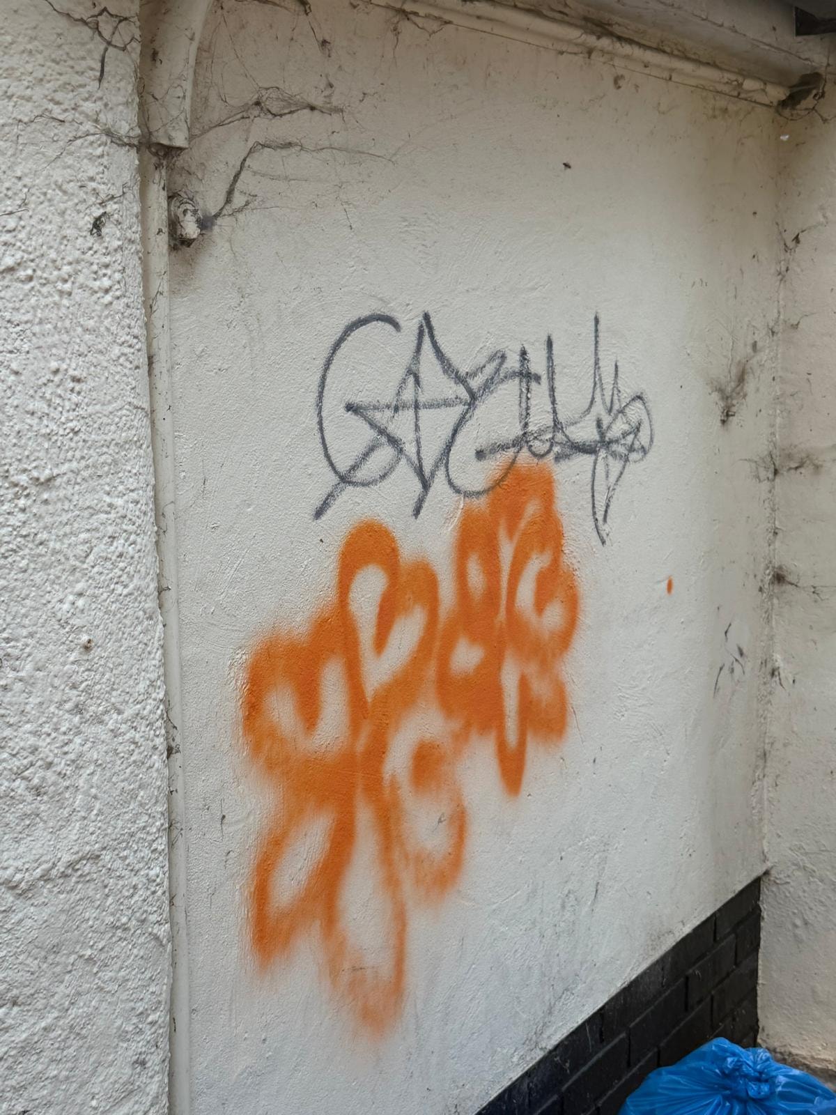 Graffiti on concrete wall before laser removal — Chelmsford retail park