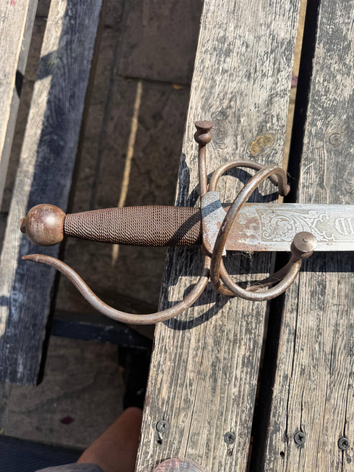 Antique heritage sword before laser cleaning — heavy rust and corrosion on guard and blade