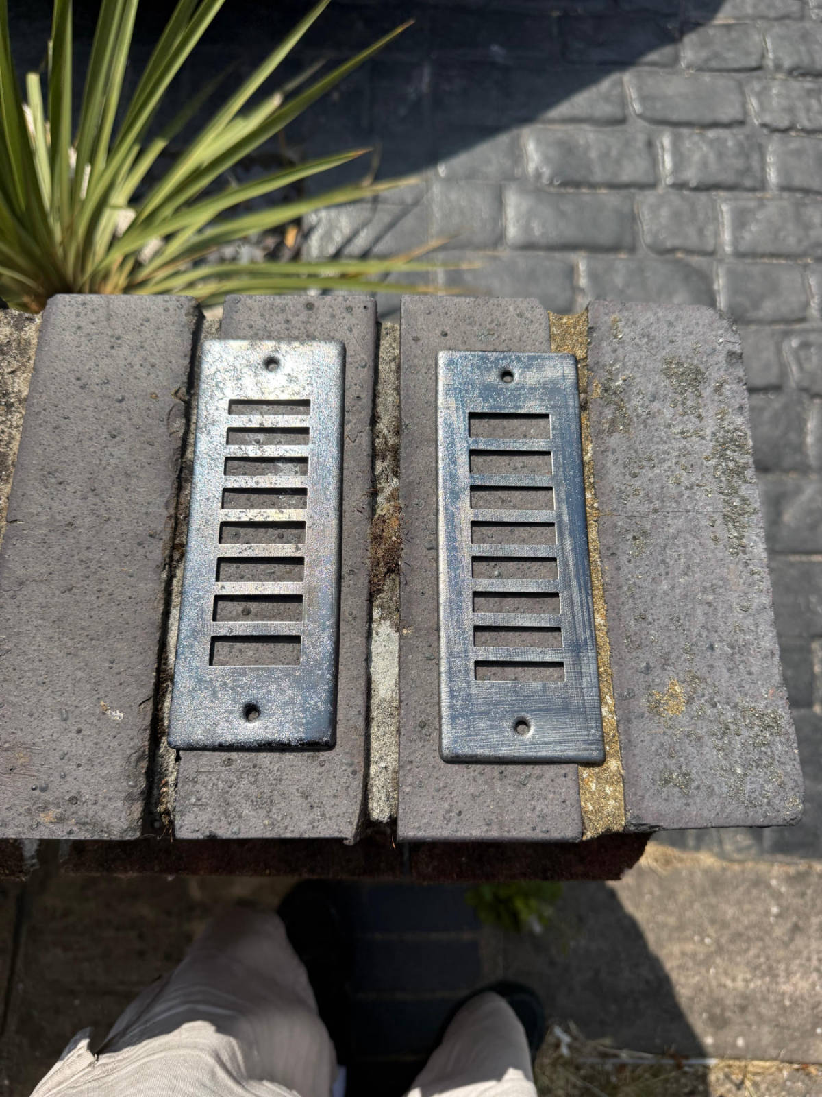 Cast iron vent grilles after laser rust removal — bare clean metal